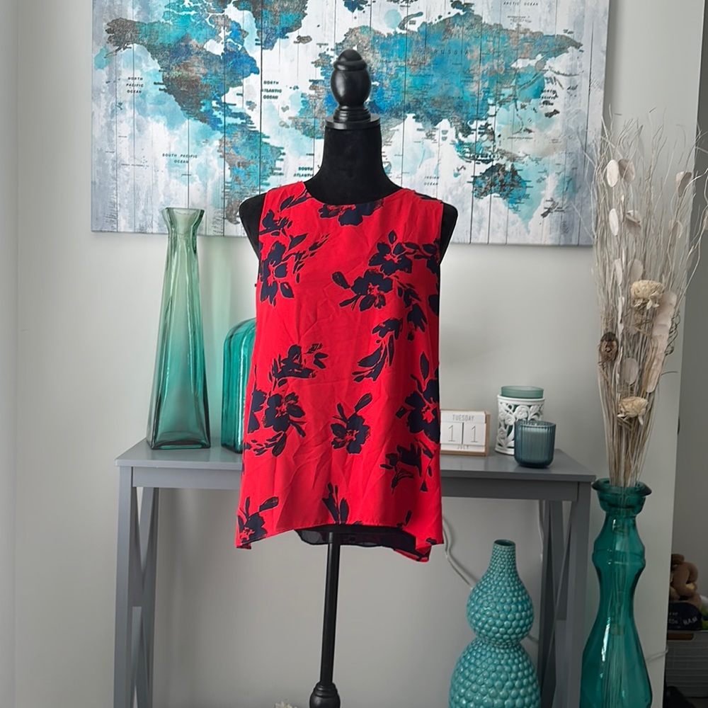Red and navy shirt with no sleeves with flower design. Alice Collection.